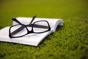 book Glasses and a book in the grass. #1 International Best Seller: Lighten Your Load. 35 Surprisingly Simple Ways to Free Yourself from Stress, Toxins, and Clutter. Free and Clear: 7 Steps to Declutter Your Home and Your Head